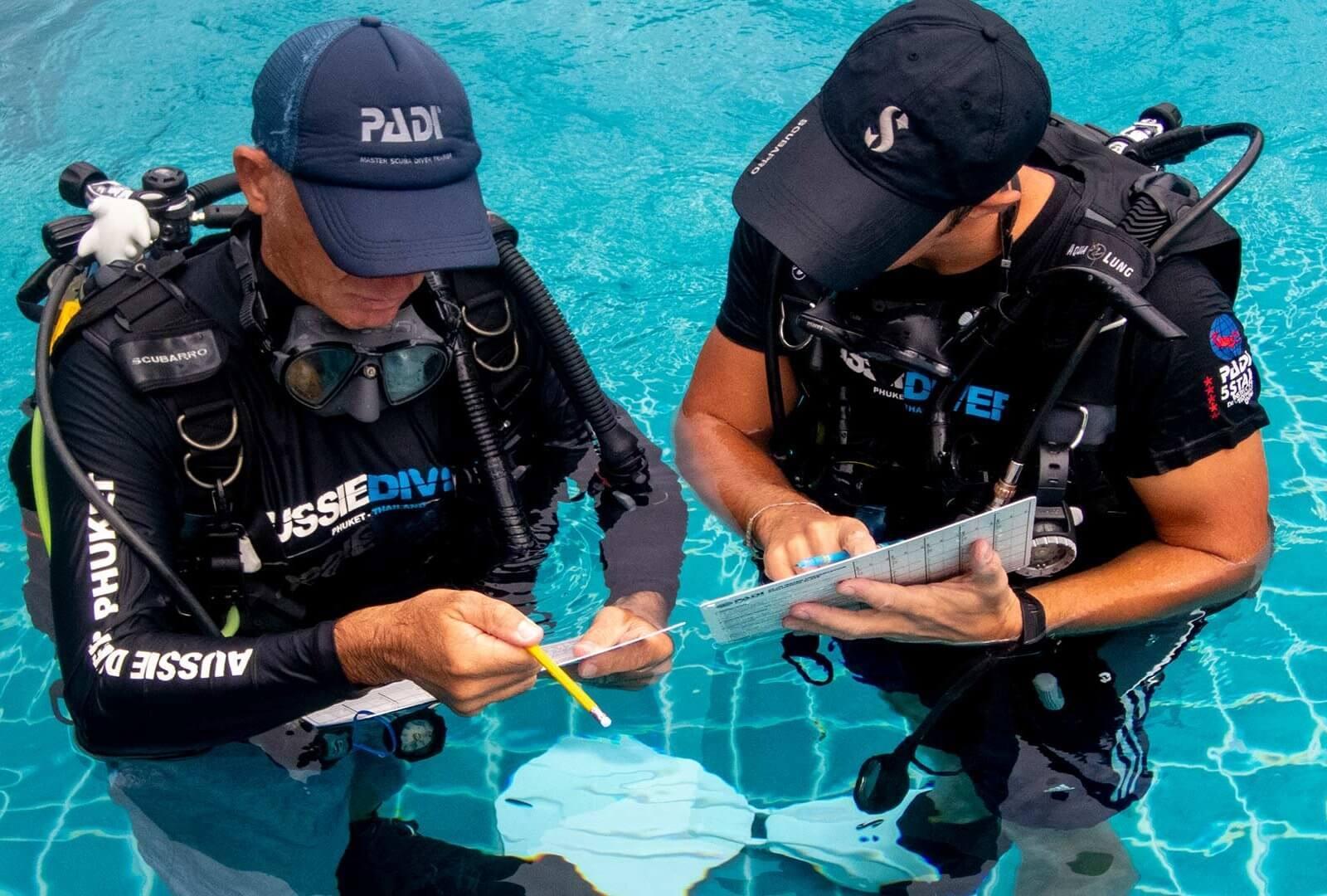 Cozumel dive instructor and divemaster leading divers on a reef