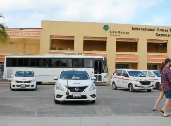 Taxis and a tour bus waiting outside the International Cruise Terminal in Cozumel