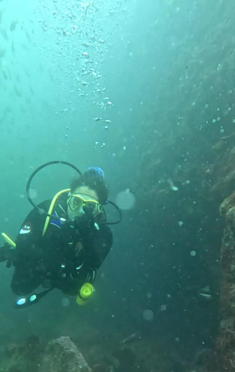 Ana Isabel diving close to a reef wall in Cozumel