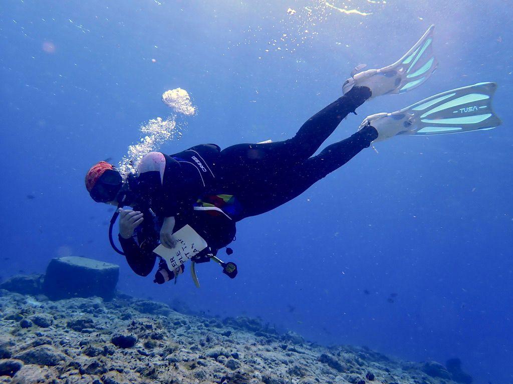 Ana Isabel, PADI dive instructor in Cozumel, in horizontal trim above a reef